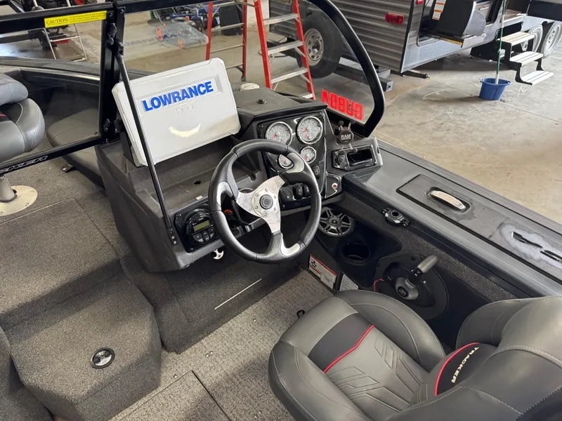 Slide: The Image of 2022 Tracker Targa V-18 Combo boat interior with steering wheel and Lowrance electronics. - 8