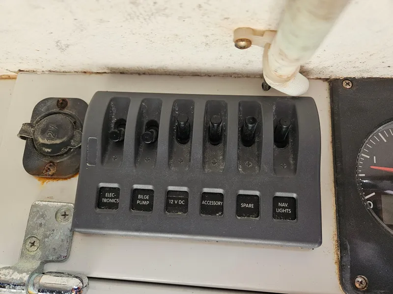 Slide: The Image of Control panel of a 2014 C&C Mega 30 One Design boat with labeled switches. - 16