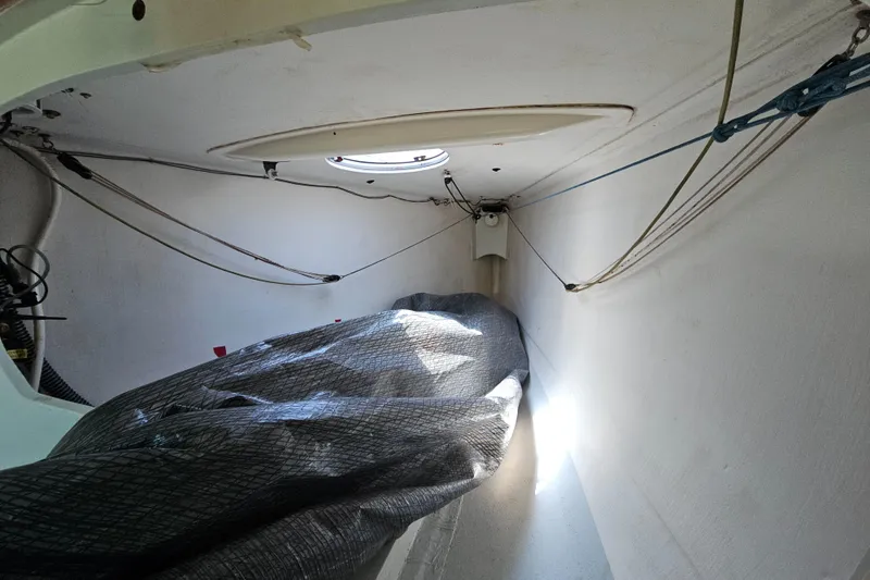 Slide: The Image of Interior of 2014 C&C Mega 30 One Design sailboat with ropes and covered equipment. - 20