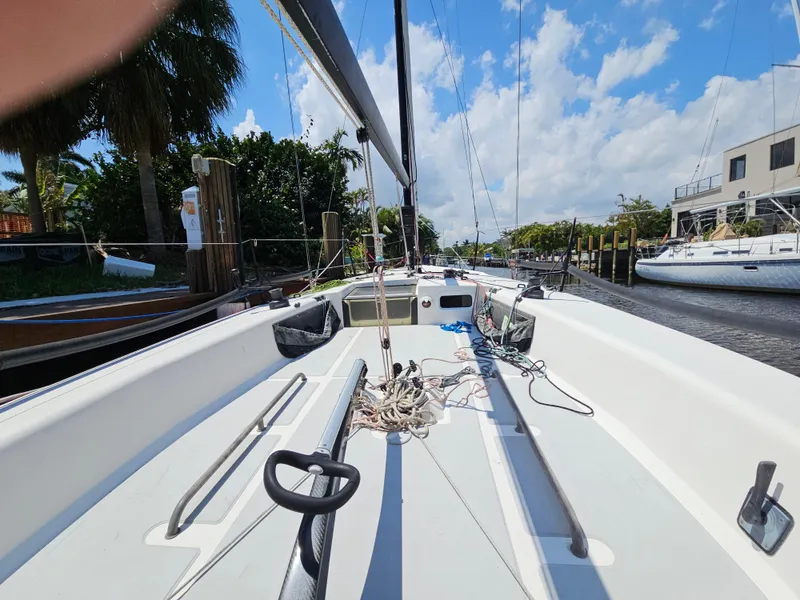 Slide: The Image of Sailboat deck view of 2014 C&C Mega 30 One Design, docked under blue sky. - 4