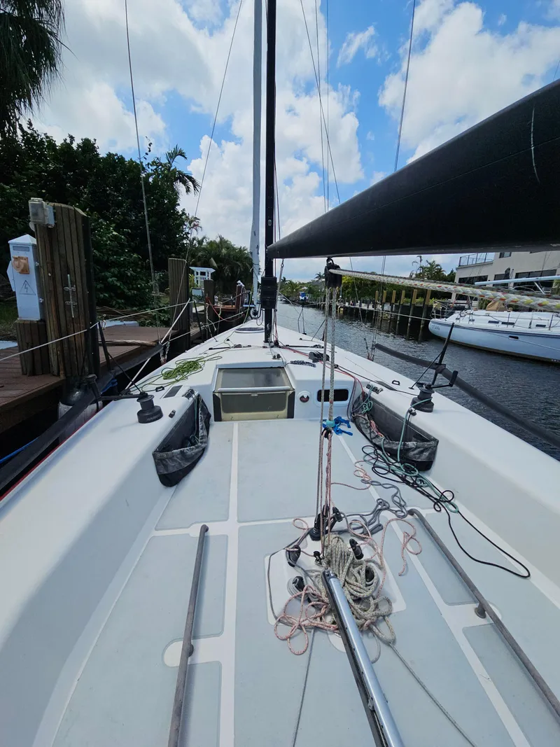 Slide: The Image of Sailboat docked, C&C Mega 30 One Design, 2014 model, clear sky, marina setting. - 5