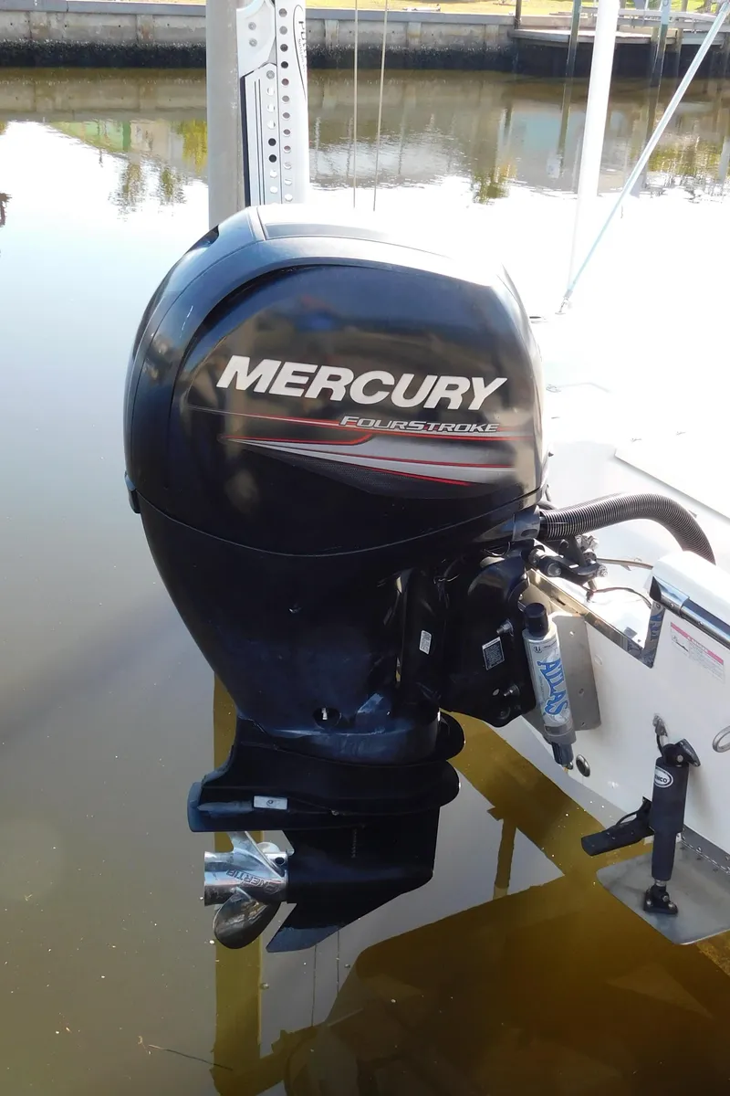Slide: The Image of Mercury outboard motor on 2014 Century 2001 Bay CC boat, docked in calm water. - 13