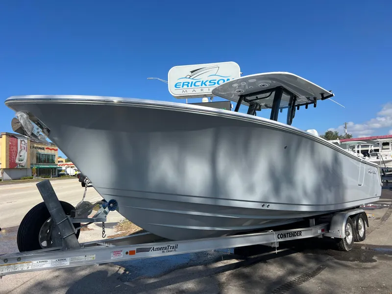 The Image of 2025 Sportsman Open 262 Center Console boat on trailer under clear blue sky. - 0