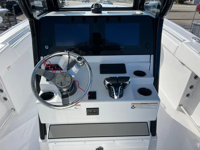Slide: The Image of 2025 Sportsman Open 262 Center Console dashboard with steering wheel and dual screens. - 10