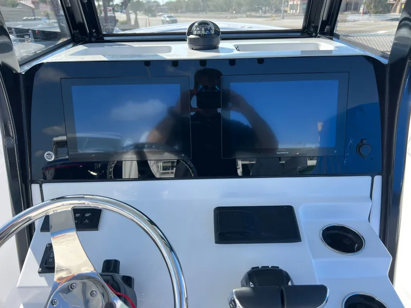 Slide: The Image of 2025 Sportsman Open 262 Center Console dashboard with dual screens and steering wheel. - 11