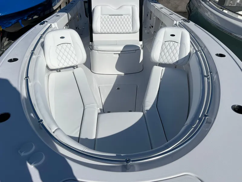 Slide: The Image of 2025 Sportsman Open 262 Center Console boat with white cushioned seating and sleek design. - 13