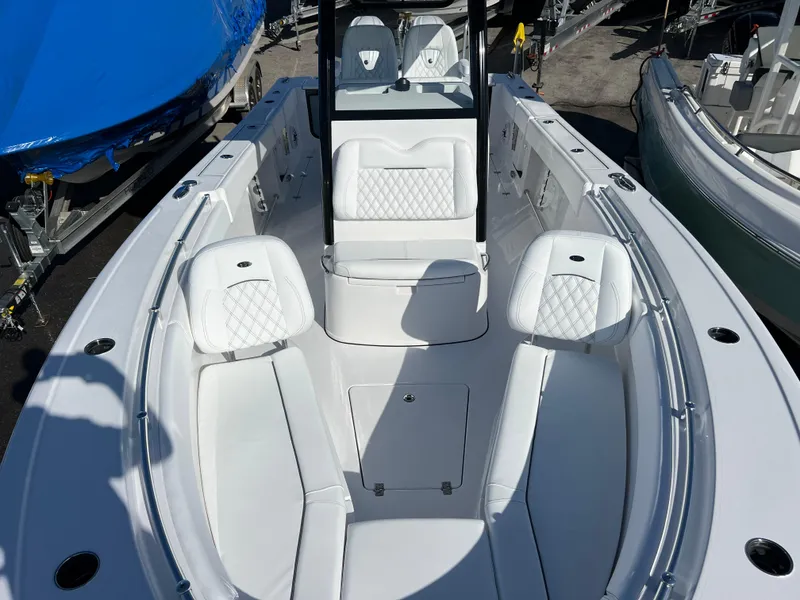 Slide: The Image of 2025 Sportsman Open 262 Center Console boat with white seating and sleek design. - 14