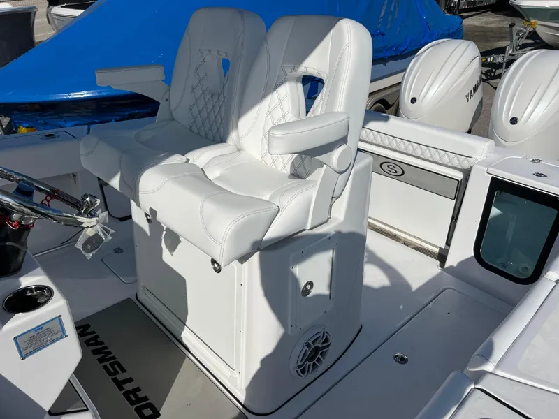 Slide: The Image of 2025 Sportsman Open 262 Center Console with white cushioned seating and Yamaha engines. - 16