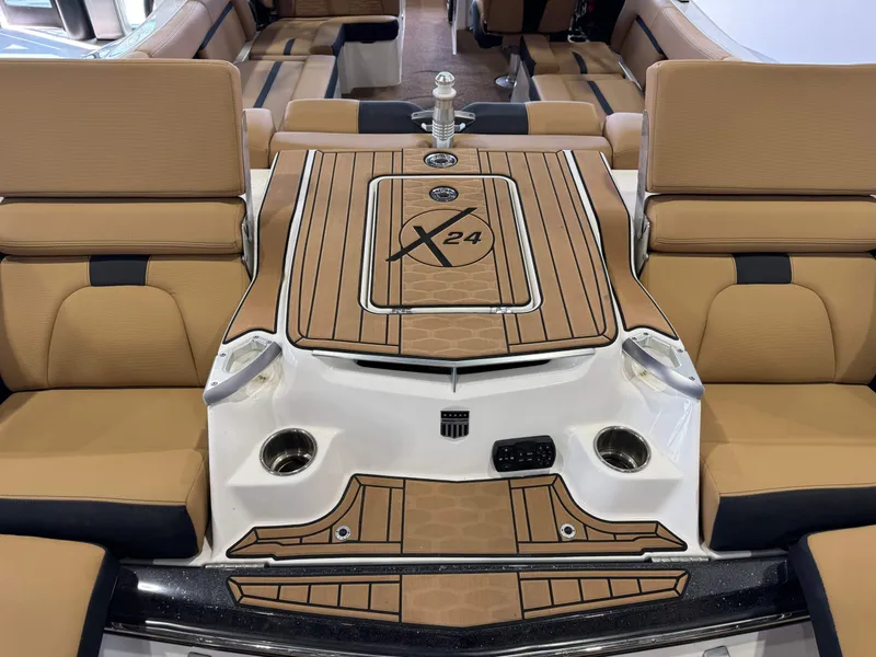 Slide: The Image of 2021 MasterCraft X24 boat interior with tan seating and stylish deck design. - 12