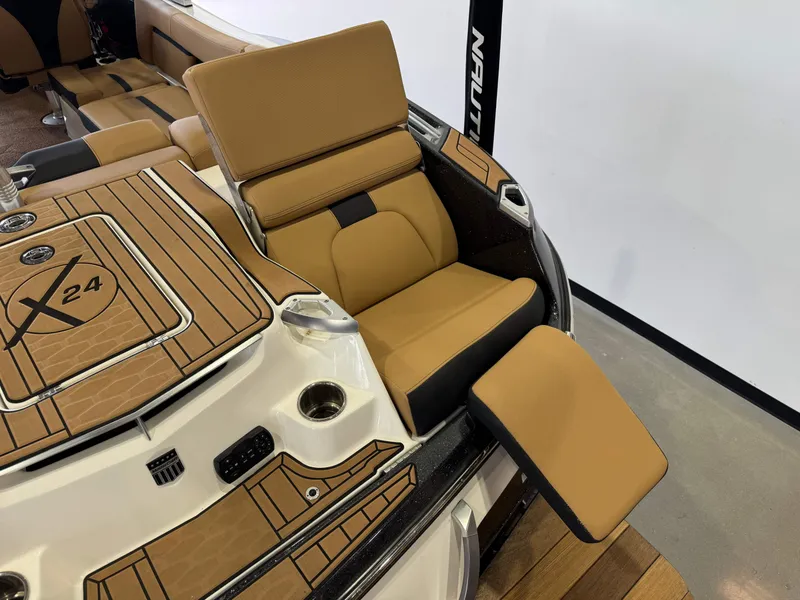 Slide: The Image of 2021 MasterCraft X24 boat interior with tan seating and deck details. - 13
