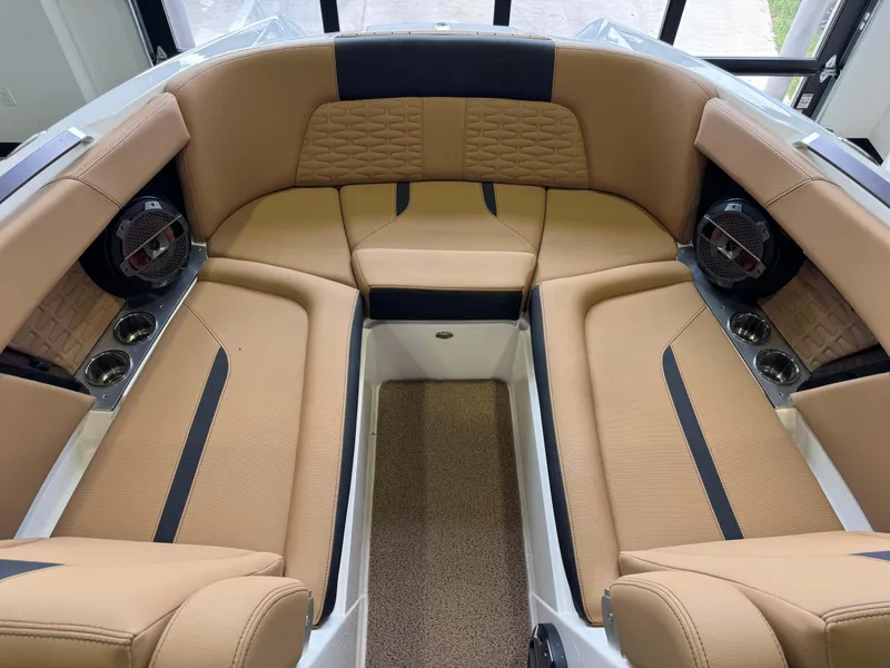 Slide: The Image of Luxurious interior of 2021 MasterCraft X24 boat with tan seating and built-in speakers. - 19