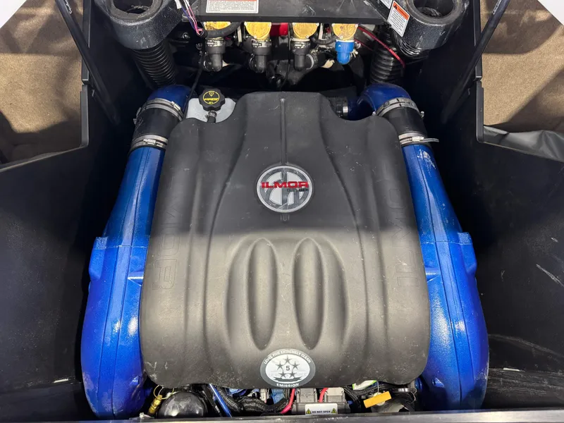 Slide: The Image of 2021 MasterCraft X24 Ilmor engine with blue accents in boat compartment. - 30