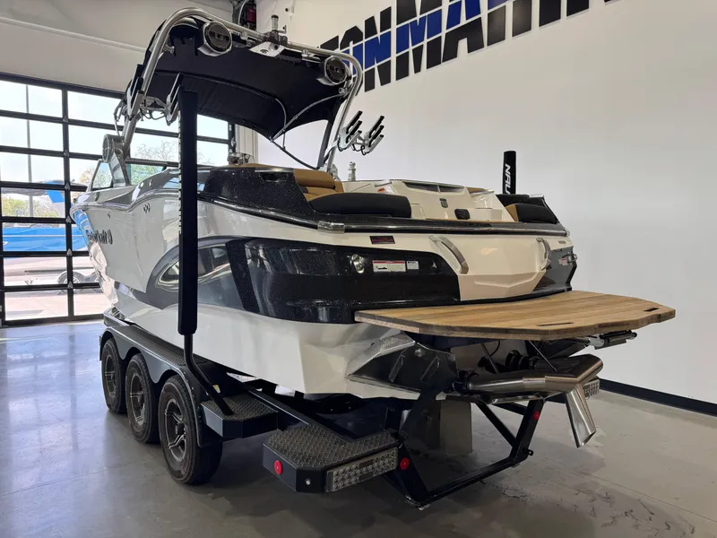 Slide: The Image of 2021 MasterCraft X24 boat on trailer in showroom, rear view. - 4