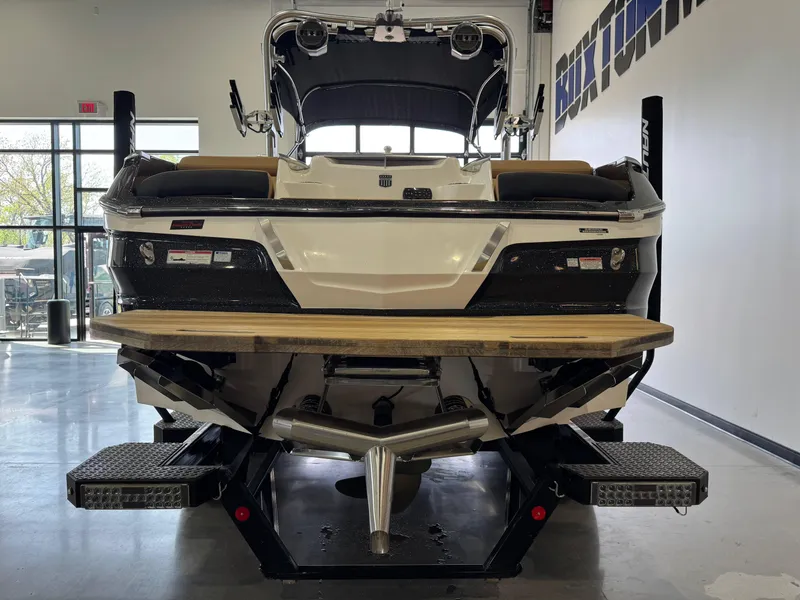 Slide: The Image of 2021 MasterCraft X24 boat in showroom, rear view with swim platform. - 5