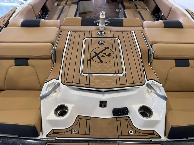 Slide: The Image of 2021 MasterCraft X24 boat interior with tan seating and stylish deck design. - 9
