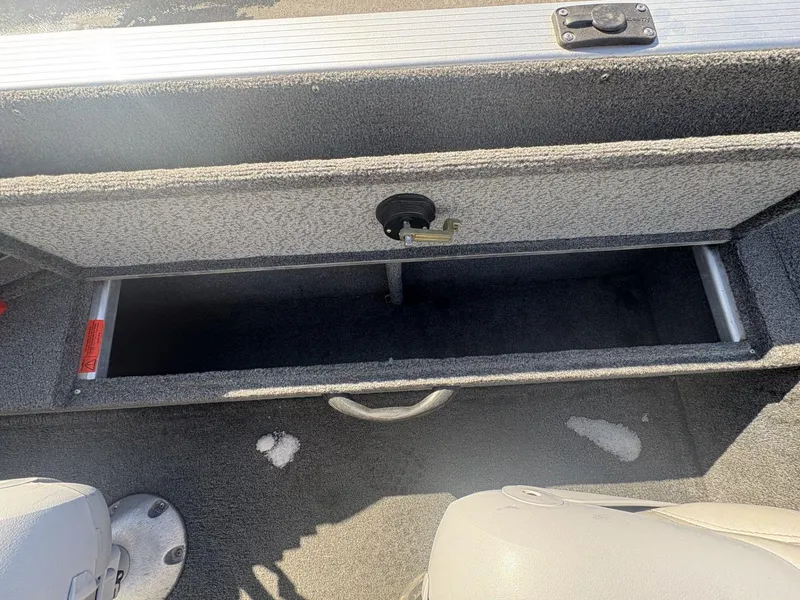 Slide: The Image of Open storage compartment in 2007 Alumacraft Navigator 165 CS boat interior. - 13