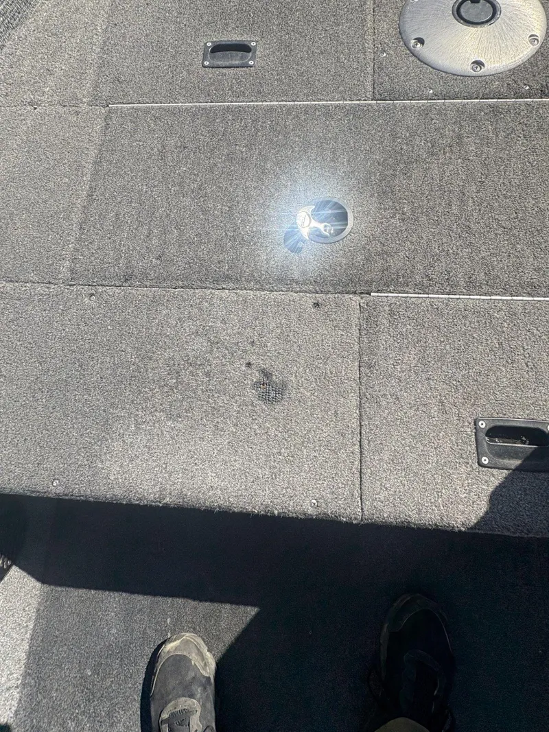 Slide: The Image of 2007 Alumacraft Navigator 165 CS boat deck with carpet and storage compartments. - 16