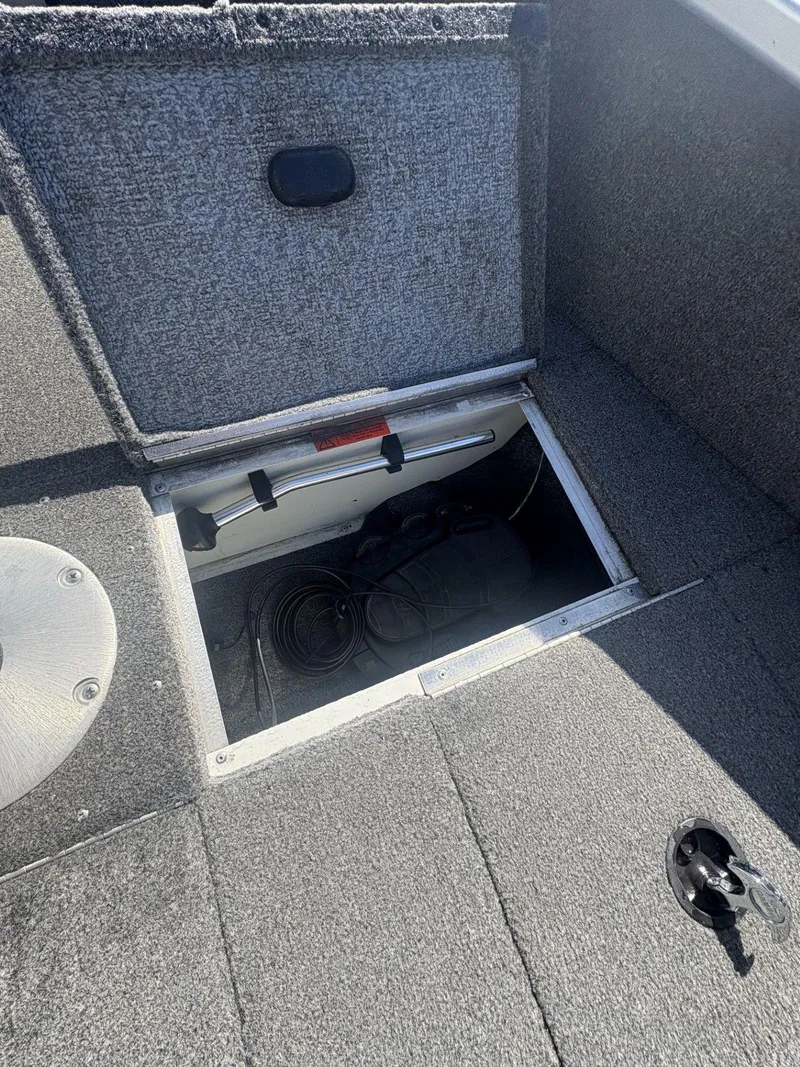 Slide: The Image of Open storage compartment in 2007 Alumacraft Navigator 165 CS boat. - 21