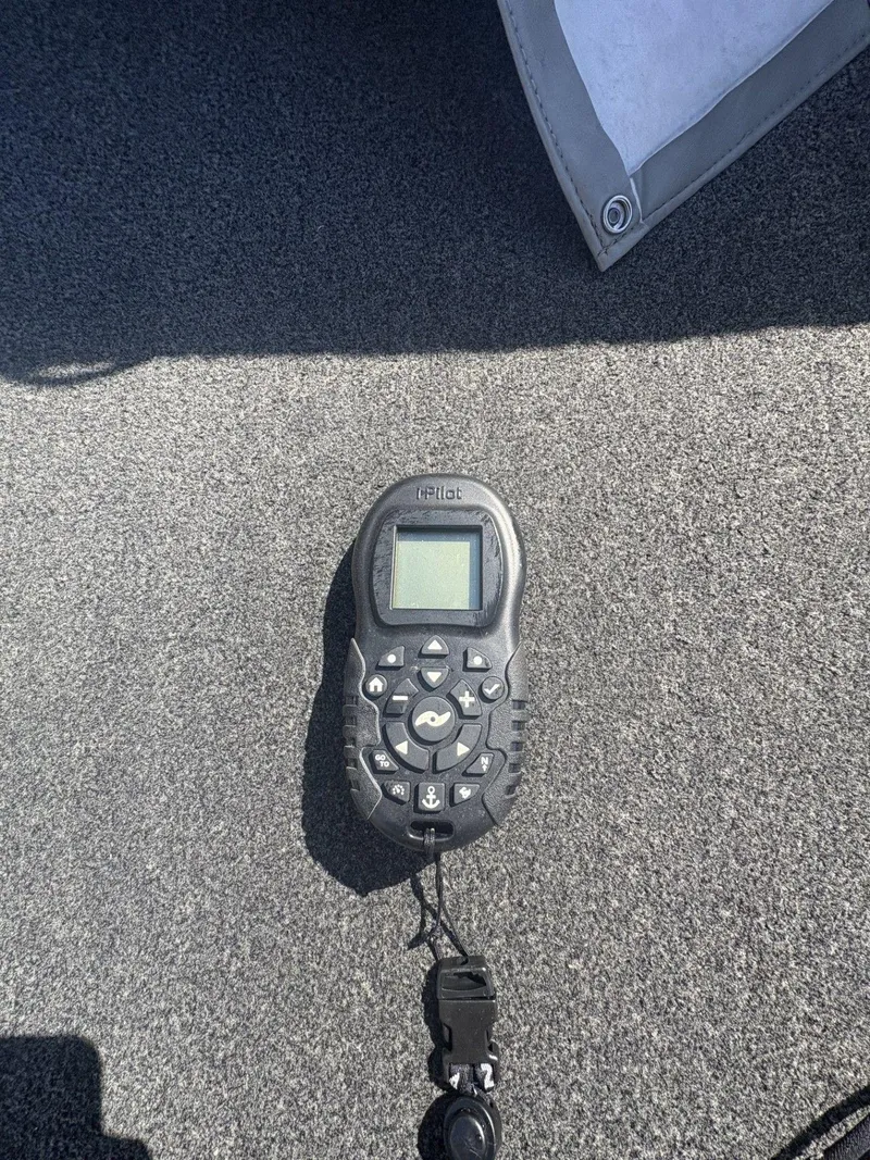 Slide: The Image of Remote control on Alumacraft Navigator 165 CS boat, 2007 model, on gray carpet. - 24