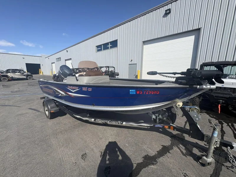 Slide: The Image of 2007 Alumacraft Navigator 165 CS boat on trailer, parked outside industrial building. - 3