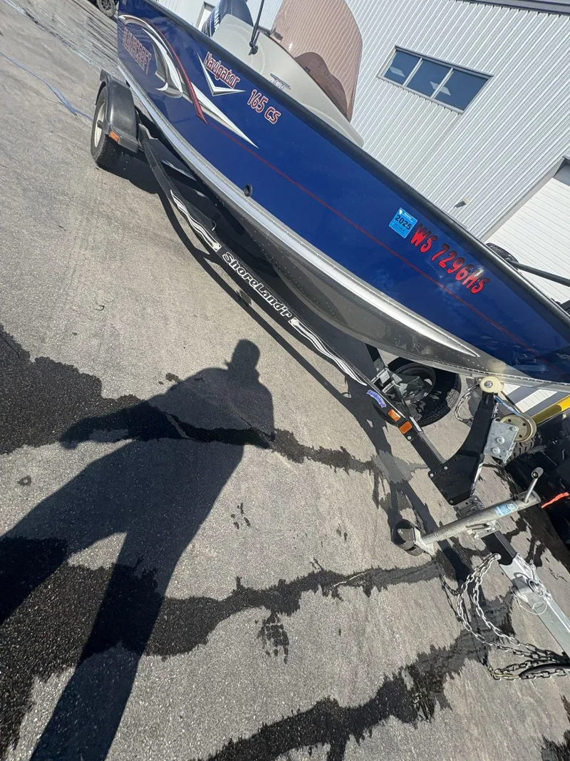 Slide: The Image of 2007 Alumacraft Navigator 165 CS boat on trailer, parked outdoors. - 30