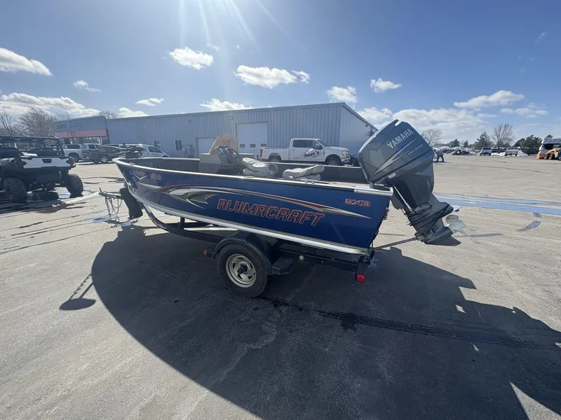 Slide: The Image of 2007 Alumacraft Navigator 165 CS boat with Yamaha outboard motor on a trailer. - 4
