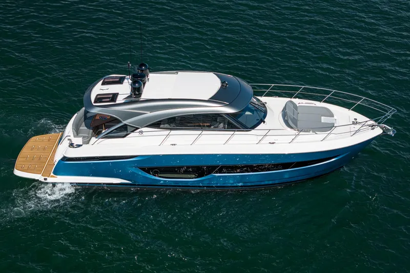 Slide: The Image of 2024 Riviera 4600 Sport Yacht cruising on open water, showcasing sleek design and luxury features. - 12