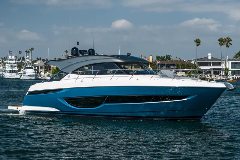 Slide: The Image of 2024 Riviera 4600 Sport Yacht cruising on a sunny day, showcasing sleek design and luxury. - 15