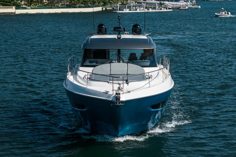 Slide: The Image of 2024 Riviera 4600 Sport Yacht cruising on open water. - 16