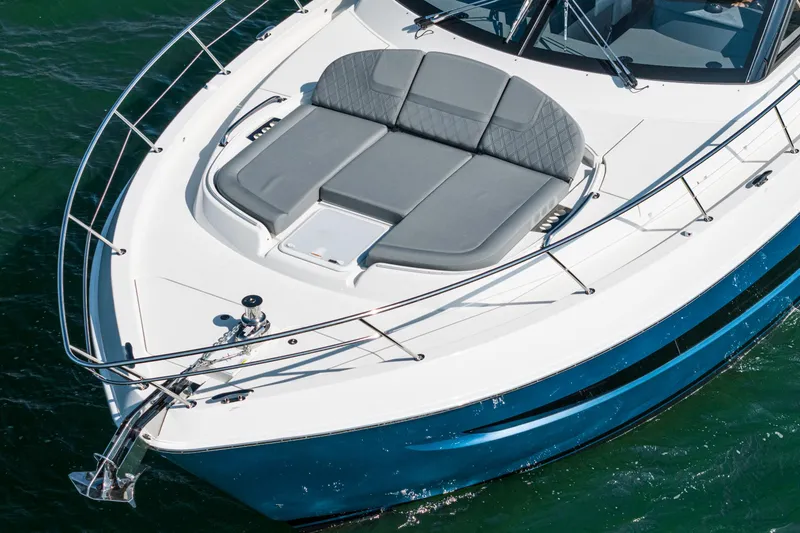 Slide: The Image of 2024 Riviera 4600 Sport Yacht with sleek design and spacious sunbathing area on deck. - 17