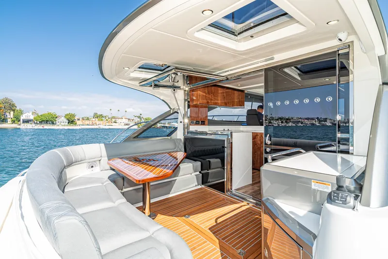 Slide: The Image of 2024 Riviera 4600 Sport Yacht with luxurious interior and waterfront view. - 25