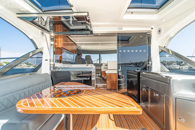 Slide: The Image of 2024 Riviera 4600 Sport Yacht interior with luxurious seating and modern amenities. - 26
