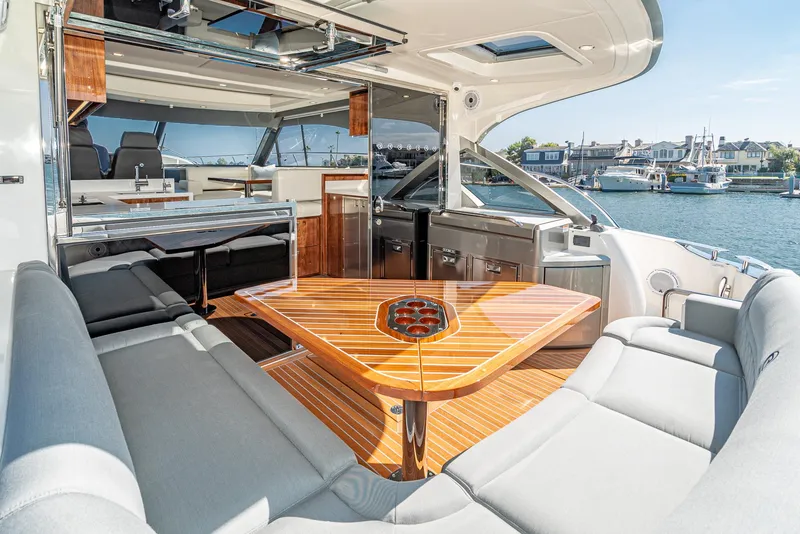 Slide: The Image of Luxurious interior of 2024 Riviera 4600 Sport Yacht with elegant seating and wooden table. - 27