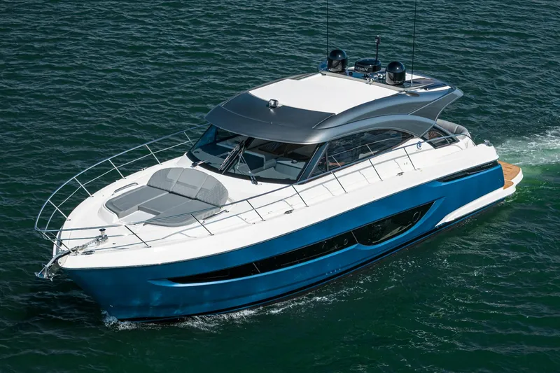Slide: The Image of 2024 Riviera 4600 Sport Yacht cruising on open water, showcasing sleek design and luxury features. - 3