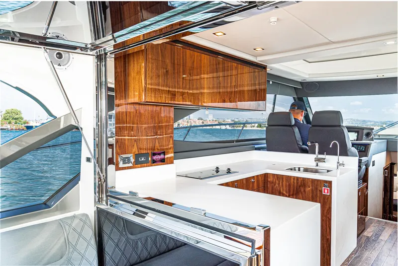 Slide: The Image of 2024 Riviera 4600 Sport Yacht interior with sleek kitchen and modern design. - 30