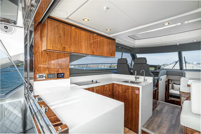 Slide: The Image of 2024 Riviera 4600 Sport Yacht interior with modern kitchen and sleek design. - 31
