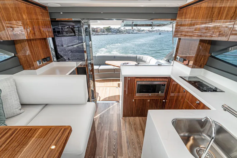 Slide: The Image of Luxurious interior of 2024 Riviera 4600 Sport Yacht with modern kitchen and ocean view. - 35