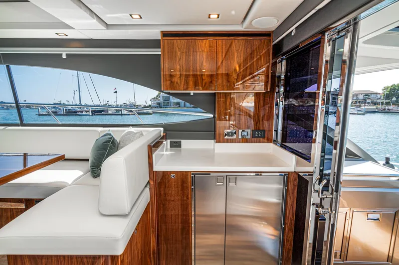 Slide: The Image of Luxurious interior of 2024 Riviera 4600 Sport Yacht with sleek wood finishes and waterfront view. - 37