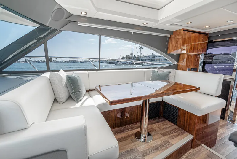 Slide: The Image of Luxurious interior of 2024 Riviera 4600 Sport Yacht with elegant seating and panoramic windows. - 39