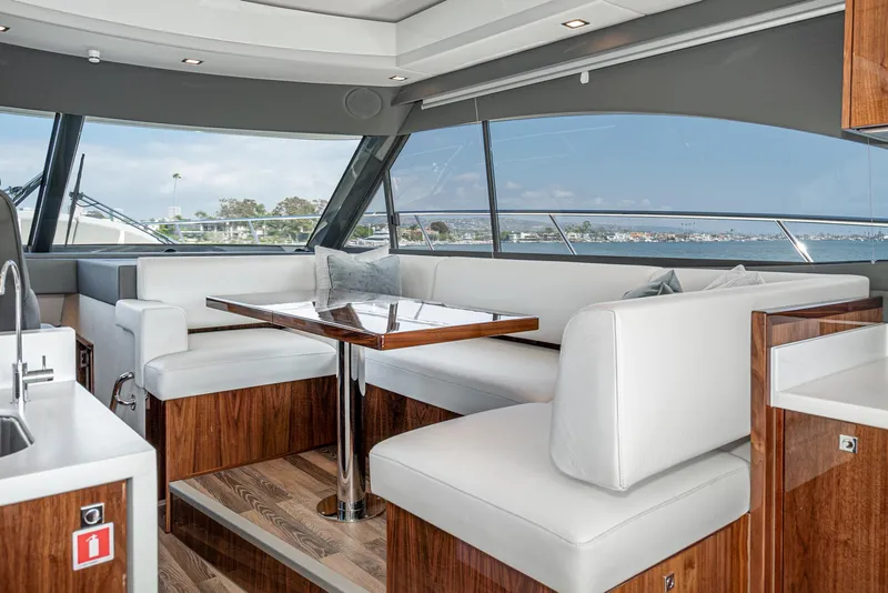 Slide: The Image of Luxurious interior of 2024 Riviera 4600 Sport Yacht with elegant seating and panoramic windows. - 40
