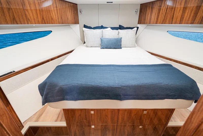 Slide: The Image of Luxurious bedroom interior of 2024 Riviera 4600 Sport Yacht with elegant wood finish. - 47
