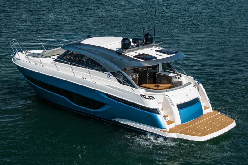Slide: The Image of 2024 Riviera 4600 Sport Yacht cruising on open water, showcasing sleek design and luxury features. - 6