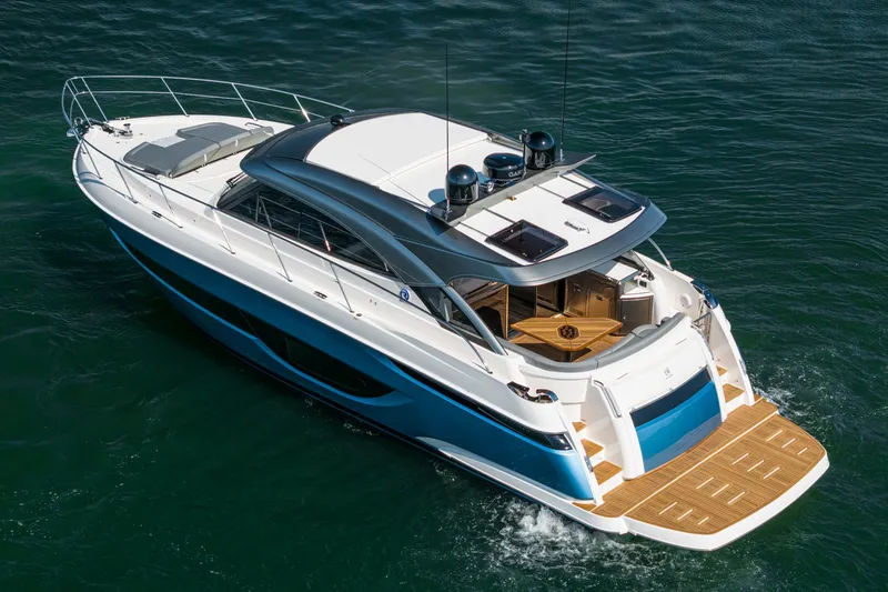 Slide: The Image of 2024 Riviera 4600 Sport Yacht cruising on water, showcasing sleek design and luxury features. - 8