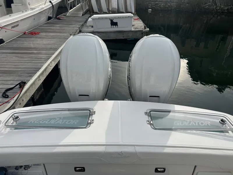 Slide: The Image of 2024 Regulator 31 boat with dual engines docked at marina. - 12
