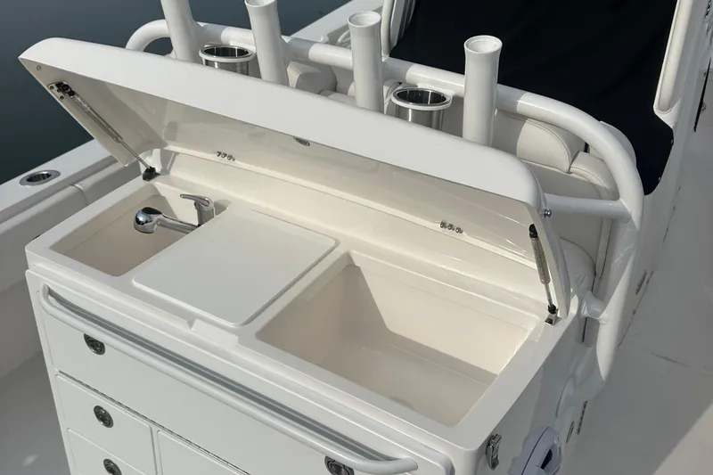 Slide: The Image of 2024 Regulator 31 boat with open storage compartment and rod holders. - 13