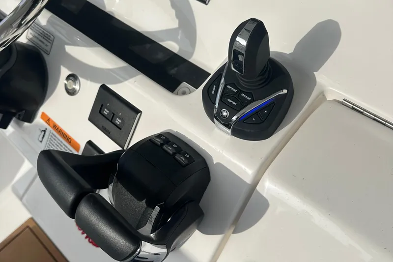 Slide: The Image of 2024 Regulator 31 boat controls with joystick and throttle on dashboard. - 17