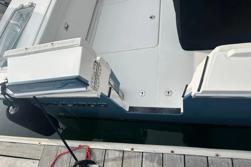 Slide: The Image of 2024 Regulator 31 boat docked, showcasing sleek design and spacious deck. - 6