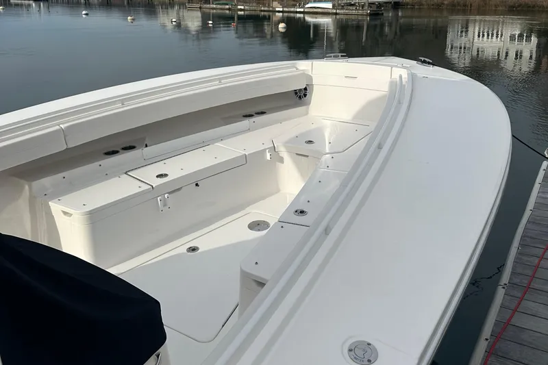 Slide: The Image of 2024 Regulator 31 boat, spacious deck, docked on calm water. - 7