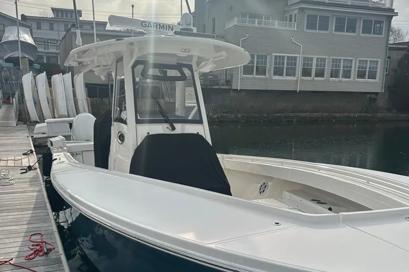 Slide: The Image of 2024 Regulator 31 boat docked, featuring Garmin equipment and sleek design. - 8