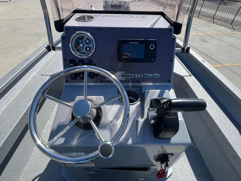 Slide: The Image of 2022 Xpress H20B Bay Boat console with steering wheel and control panel. - 10